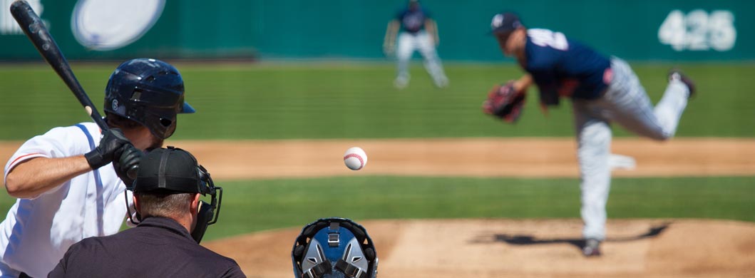 Pitcher pitching a ball to a batter